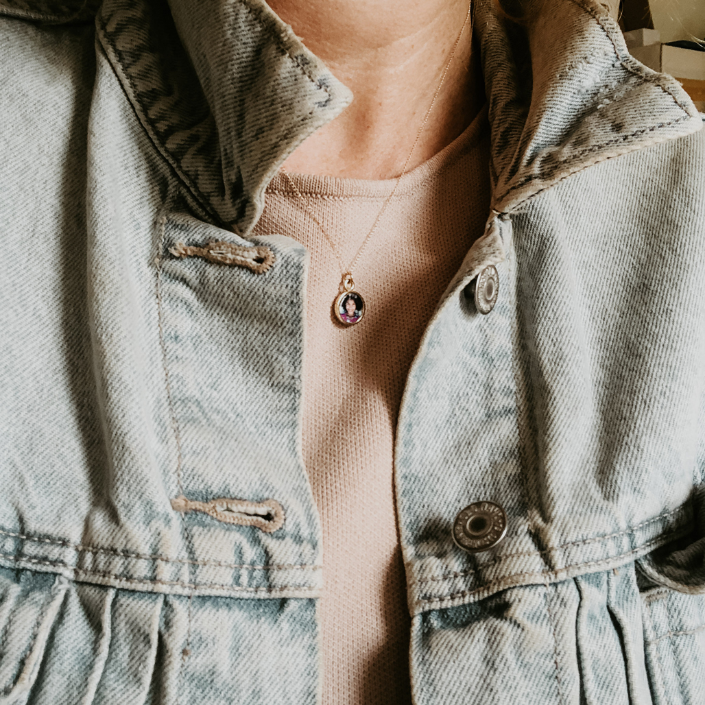 petite open solid 14k gold locket with photograph on woman in jean jacket