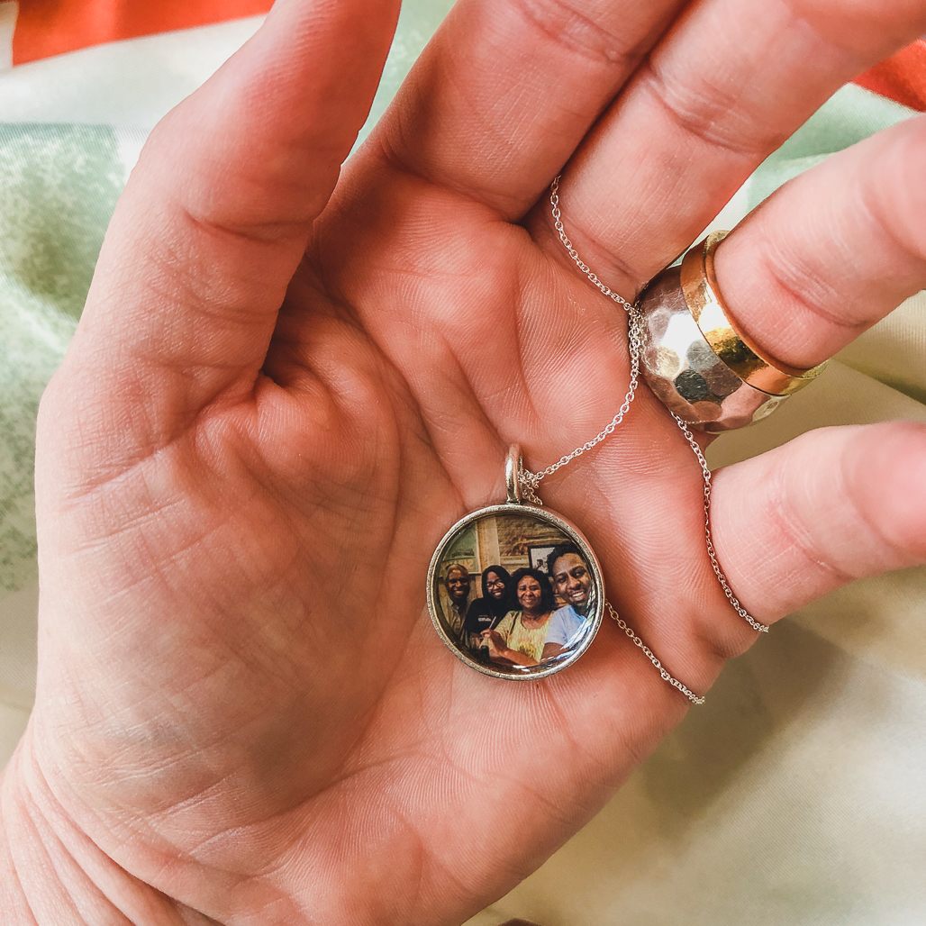 The Silver Penny Locket with Four People Inside