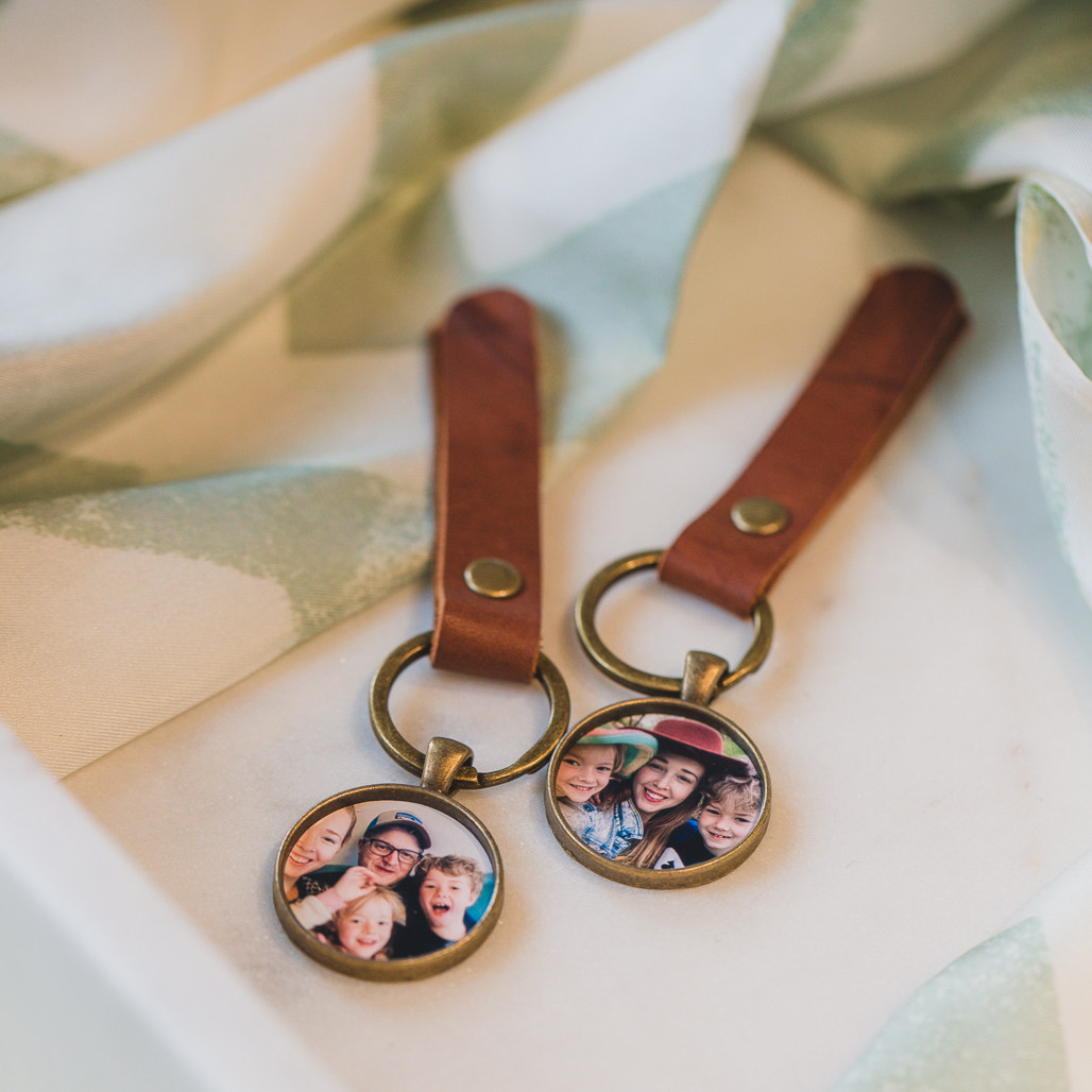 leather strapped keychain with a bronze pendant that holds a photo inside as a locket for men or anyone who wants to have a locket that's not a necklace