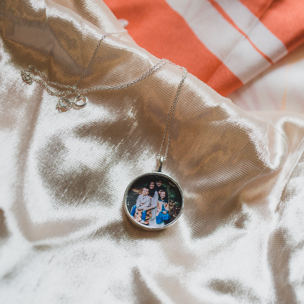 photo of erin remme and her family in a round silver locket while she battled stage four breast cancer