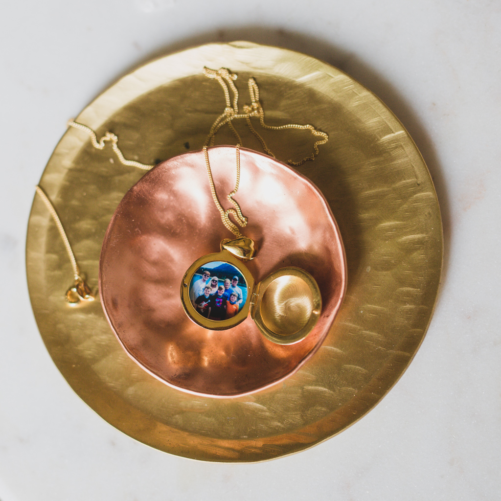 gold round locket with family picture inside from the locket sisters