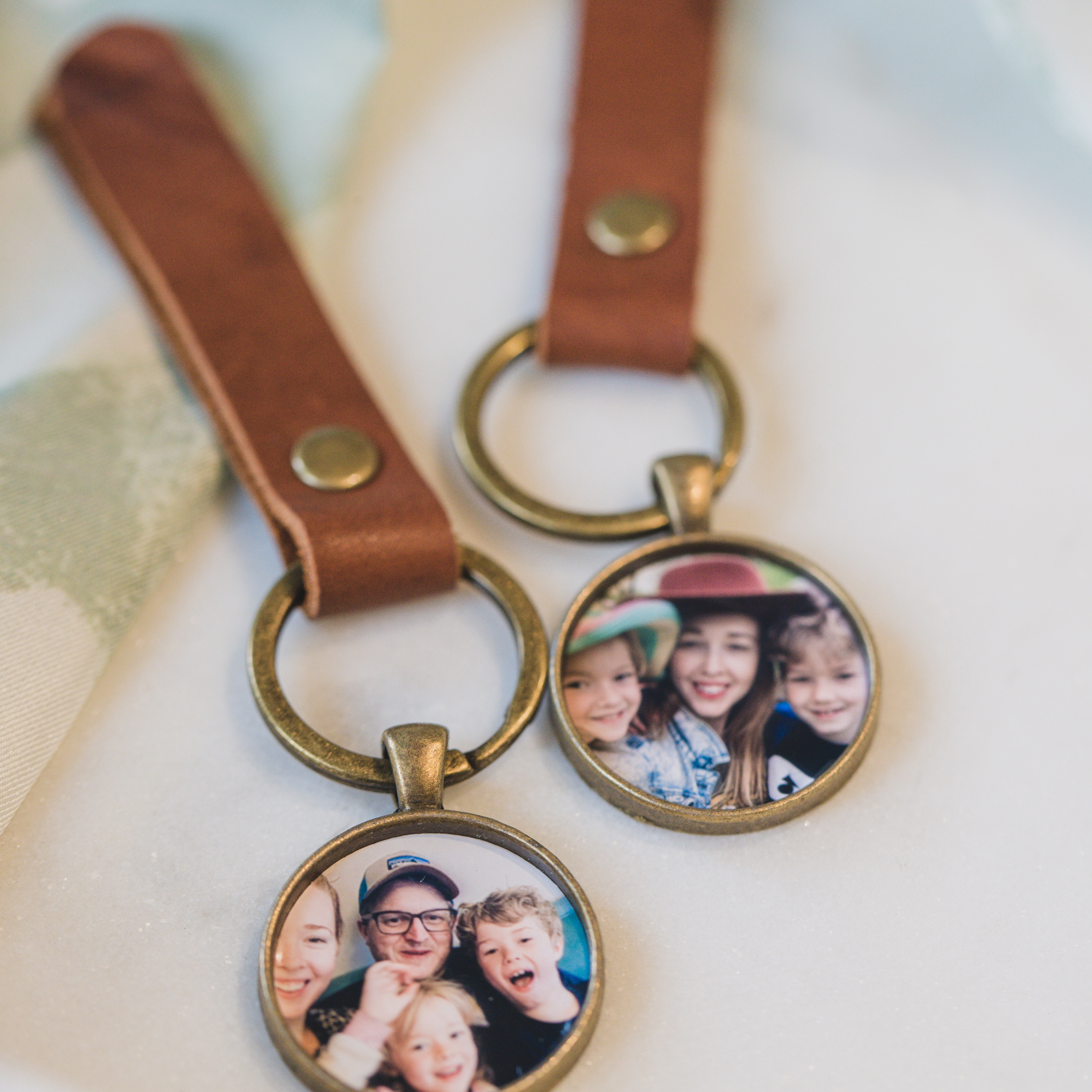 leather strapped keychain with a bronze pendant that holds a photo inside as a locket for men or anyone who wants to have a locket that's not a necklace