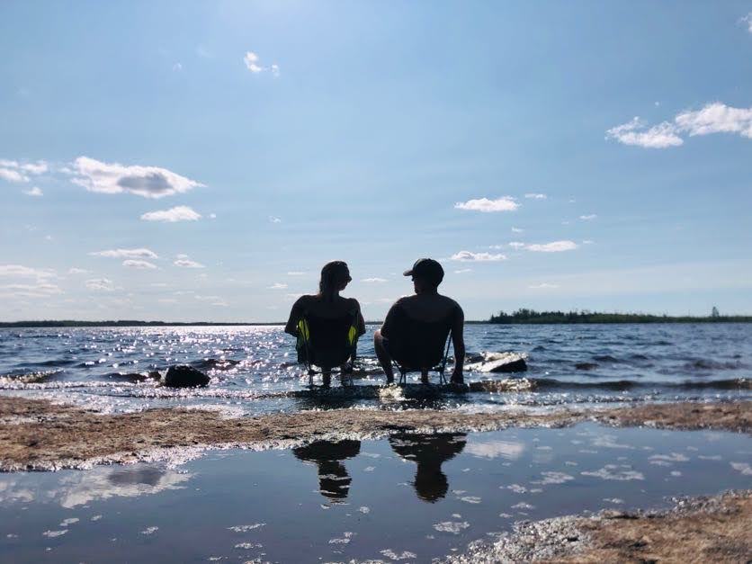 couple on chairs in water on lake isabella in the boundary waters canoe area wilderness bwca
