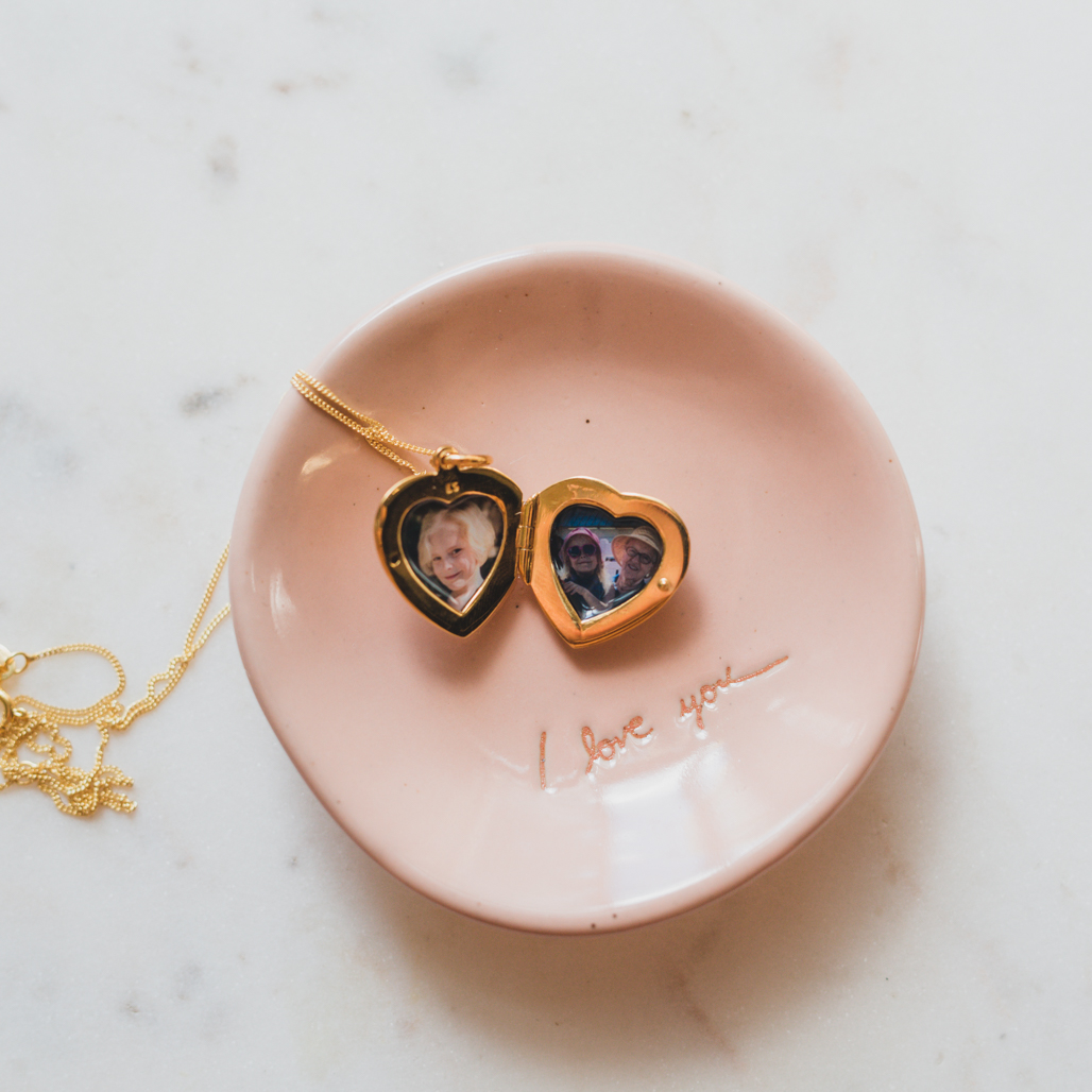 small heart locket with two pictures inside for grandmother with granddaughter who passed away