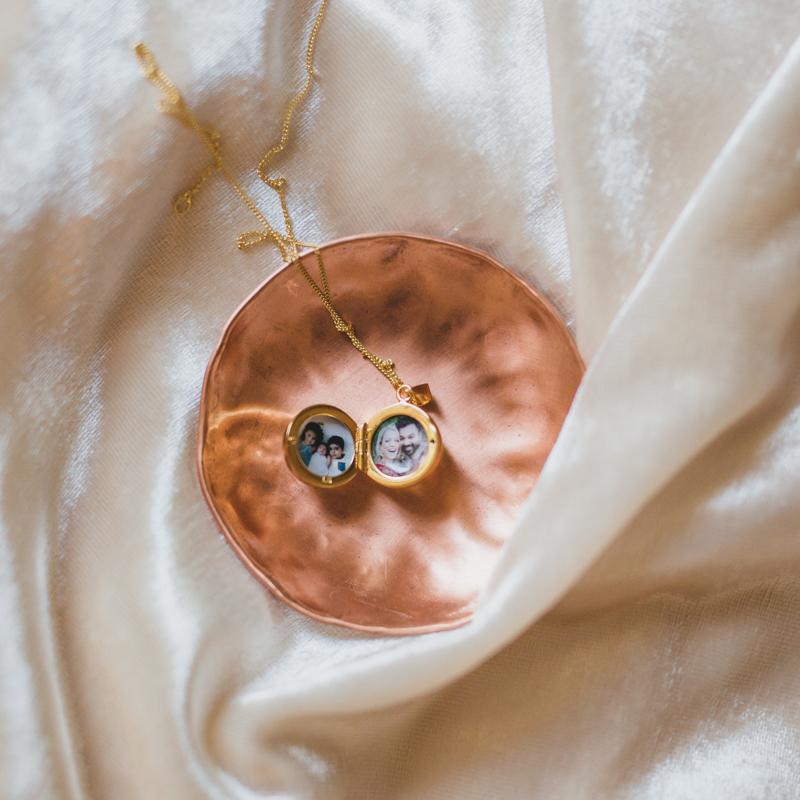 gold disco ball locket with two family pictures placed inside