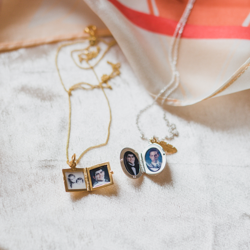 square 14k gold petite double photo locket with pictures of two men who have both passed away, and another of her daughters hugging on a white backdrop