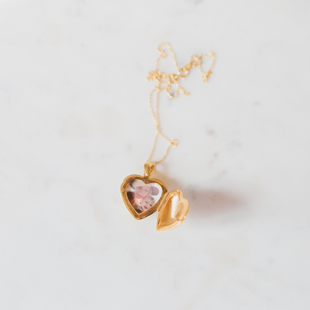 gold heart locket pendant that can hold two photos inside