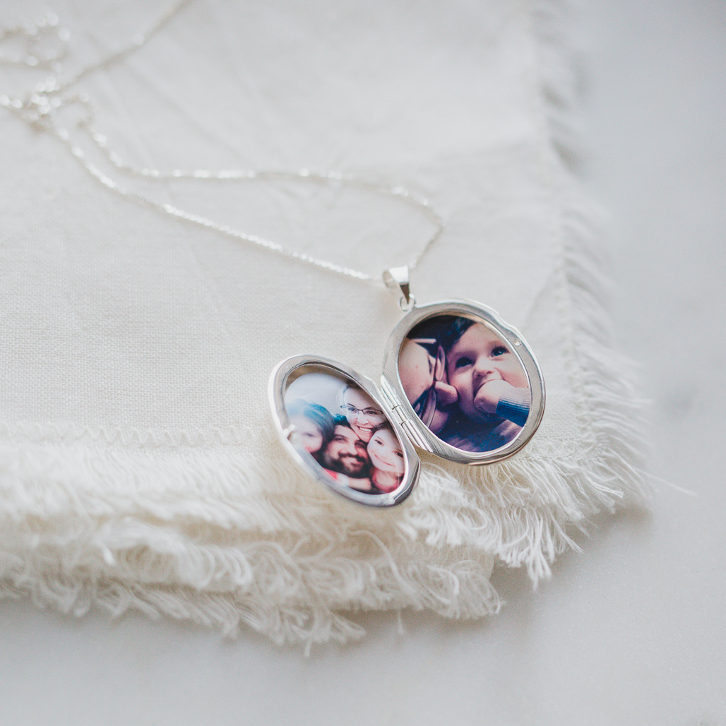 silver etched locket with photo of son who is battling cancer and family inside