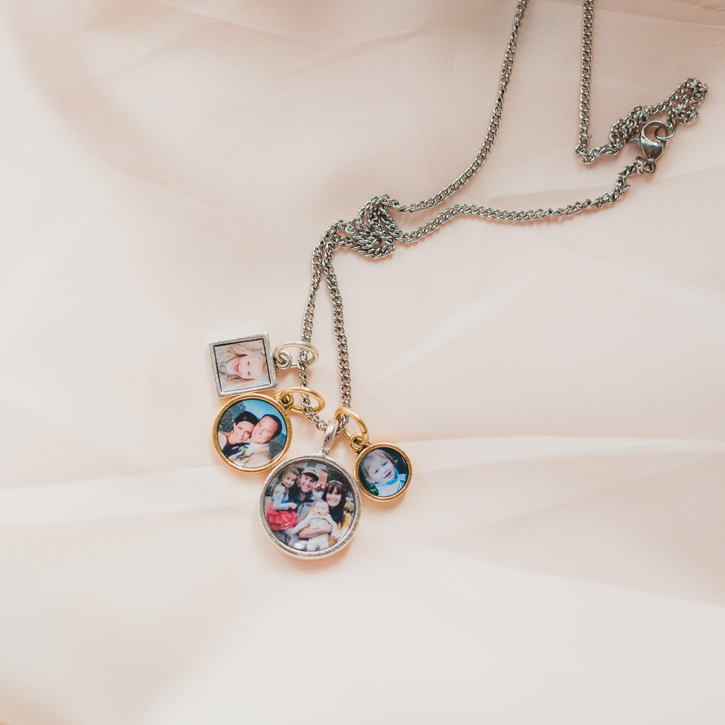 charm locket with four images of family and wedding and children inside