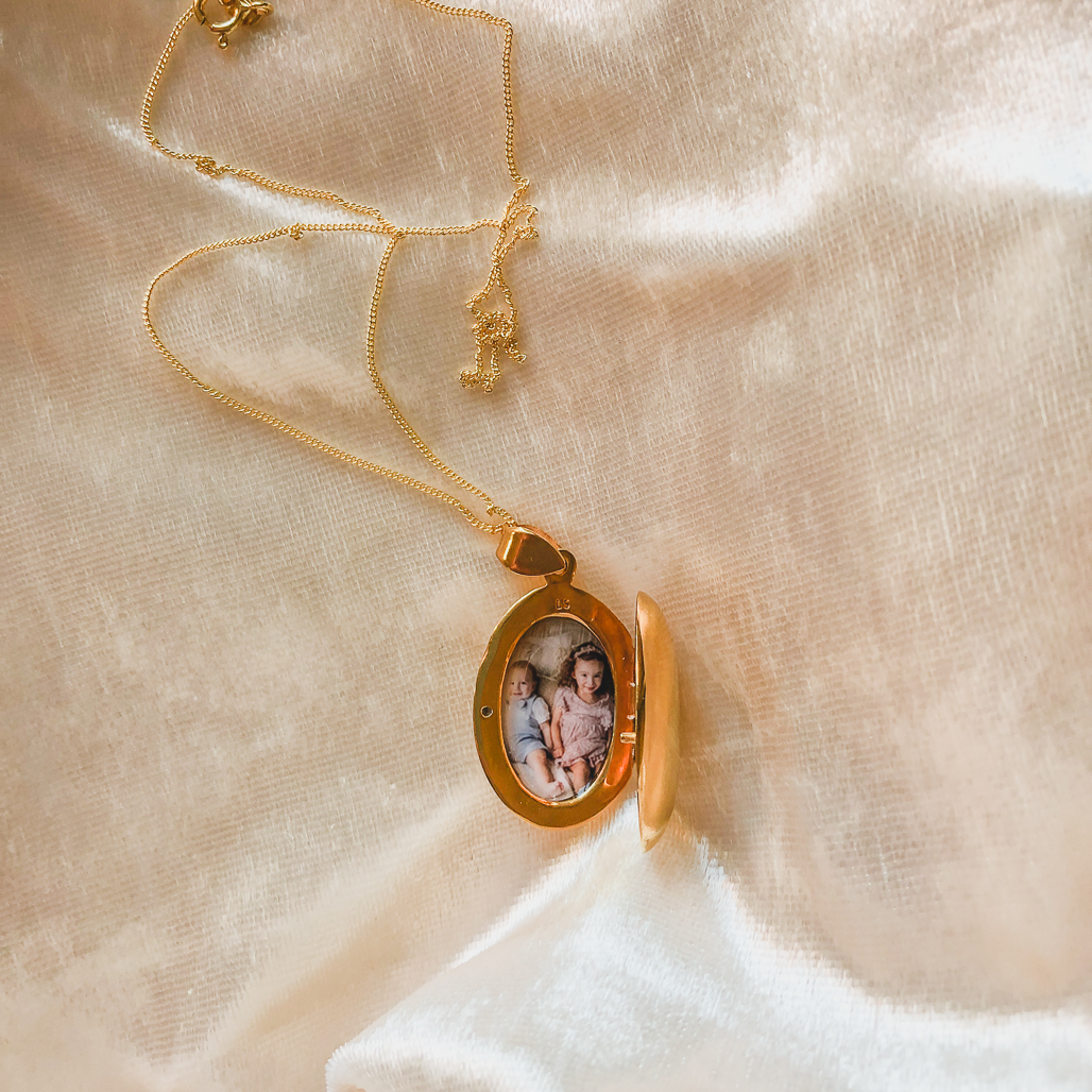 gold stacy locket with picture of children inside