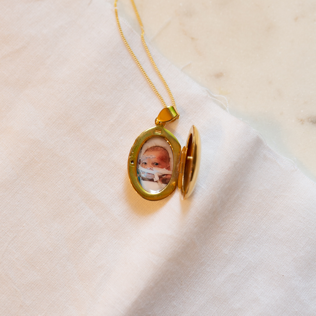 gold oval stacy locket with photo of son inside who passed away
