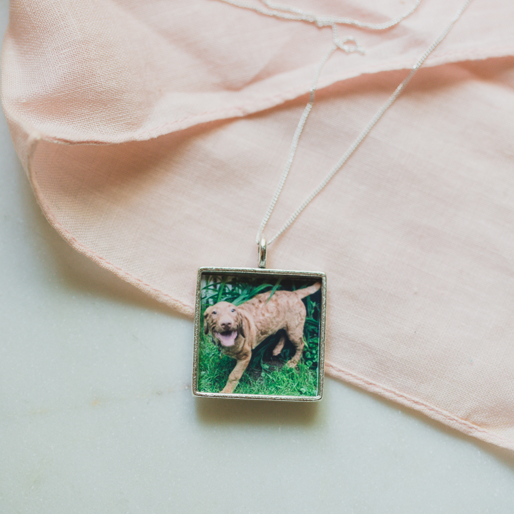 open silver square pendant locket with "pandemic puppy" photo inside