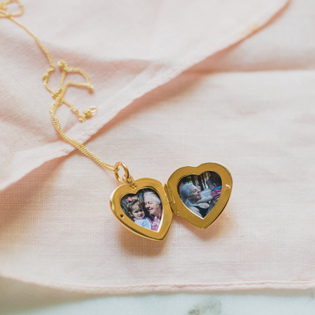 double photo locket for grandmother, a petite gold heart locket with photos of her with her grandchildren
