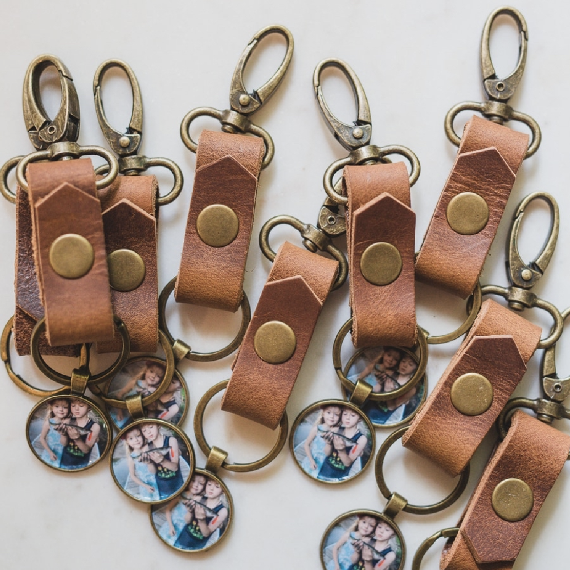 leather strapped keychain with a bronze pendant that holds a photo inside as a locket for men or anyone who wants to have a locket that's not a necklace