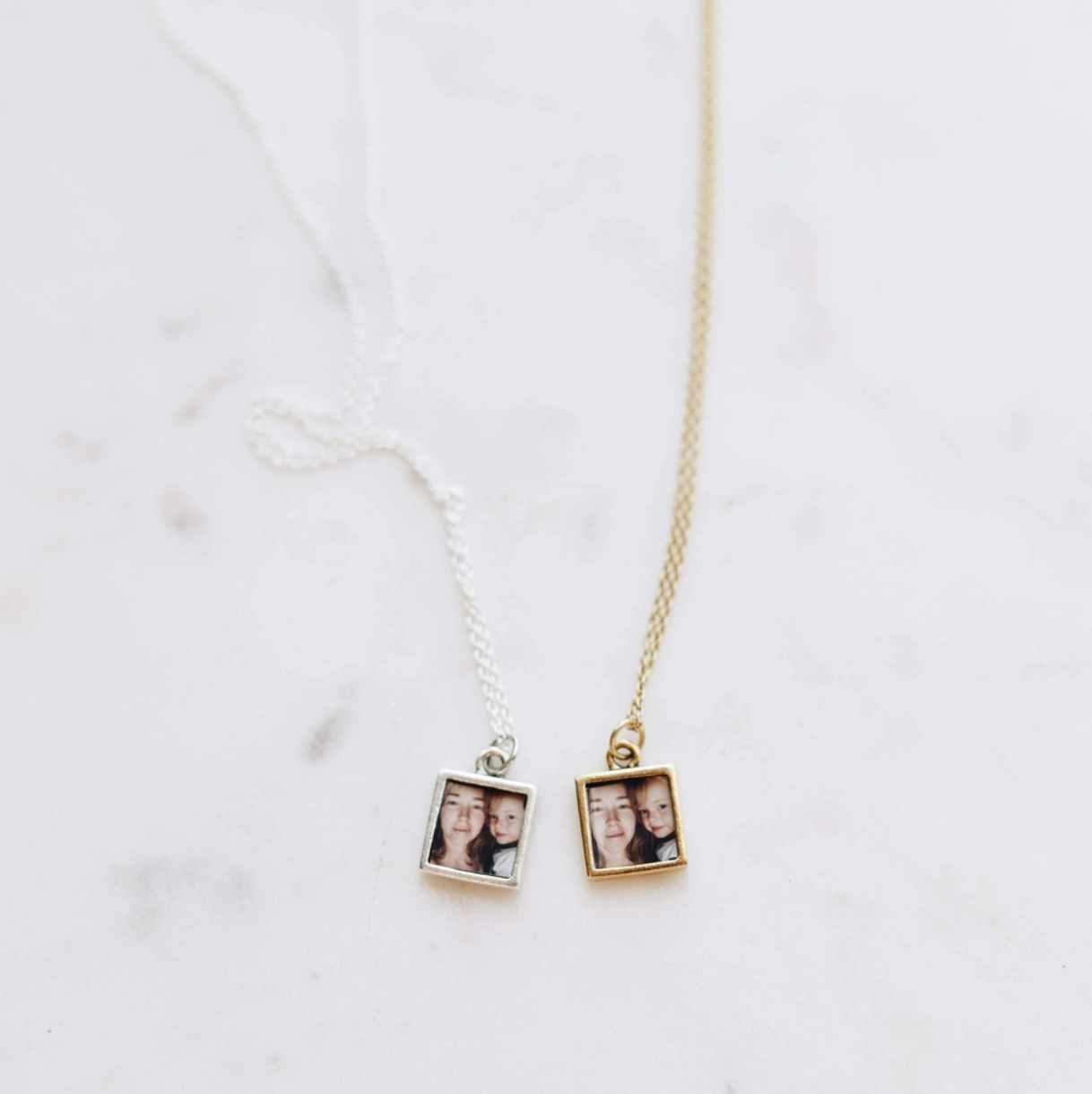 small square locket pendant in gold and silver holding a tiny photograph that they put inside for you